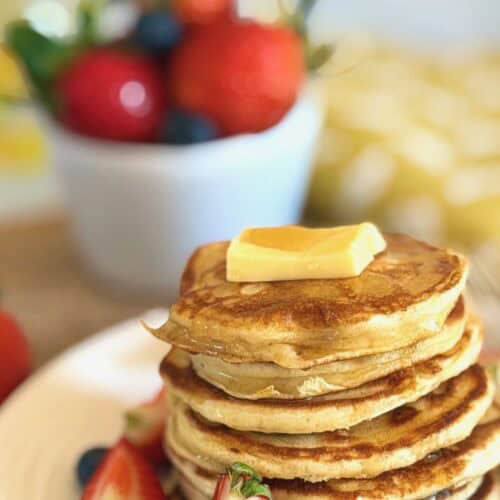 cottage cheese pancakes with fresh red berries, butter and syrup