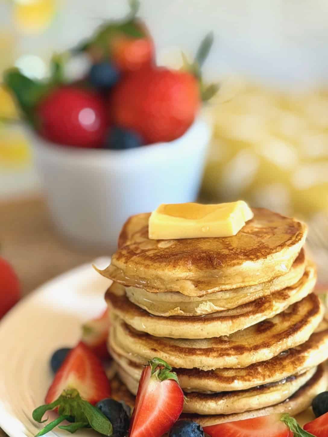 cottage cheese pancakes with fresh red berries, butter and syrup