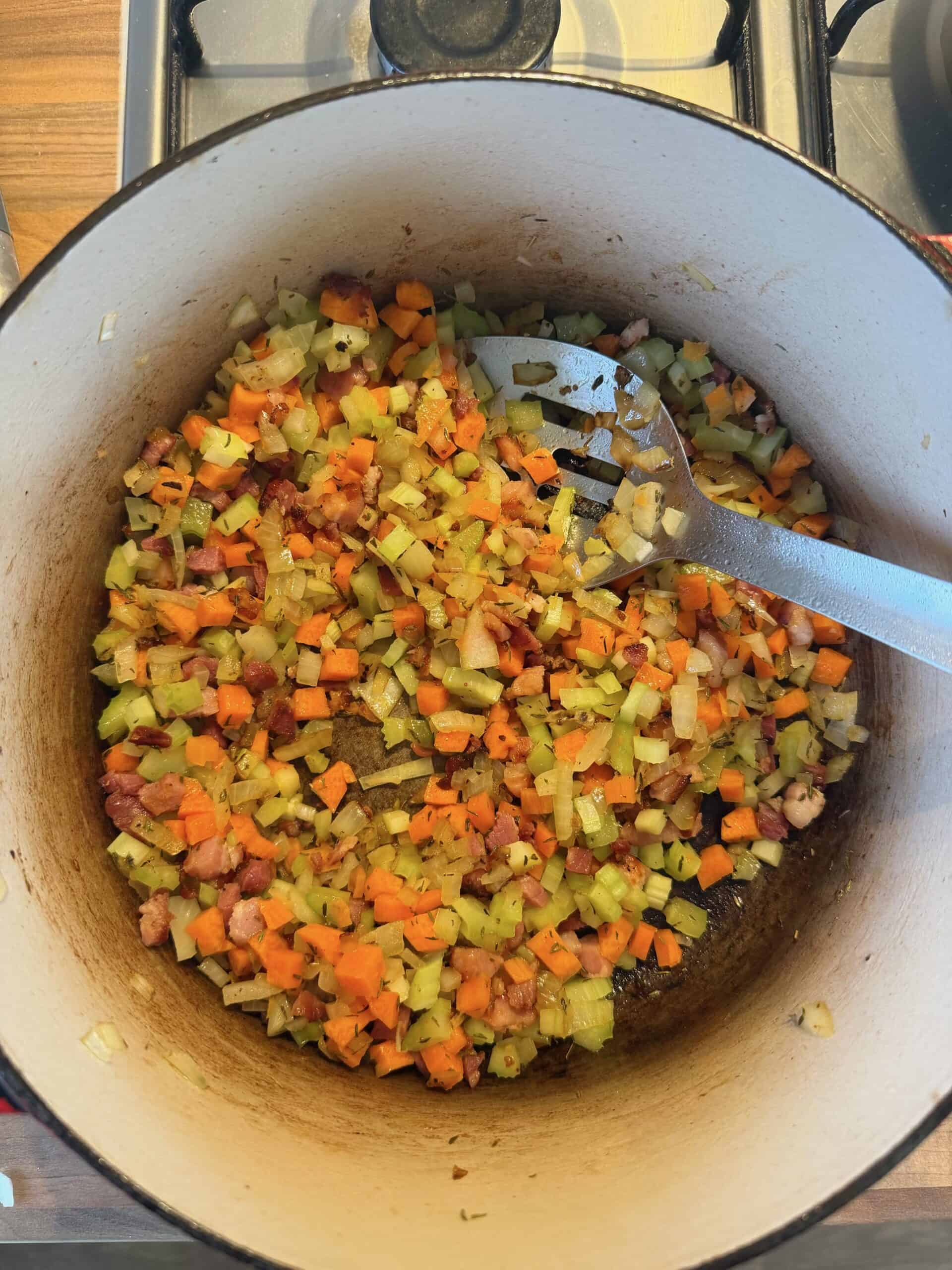 sautéing colourful vegetables in pan