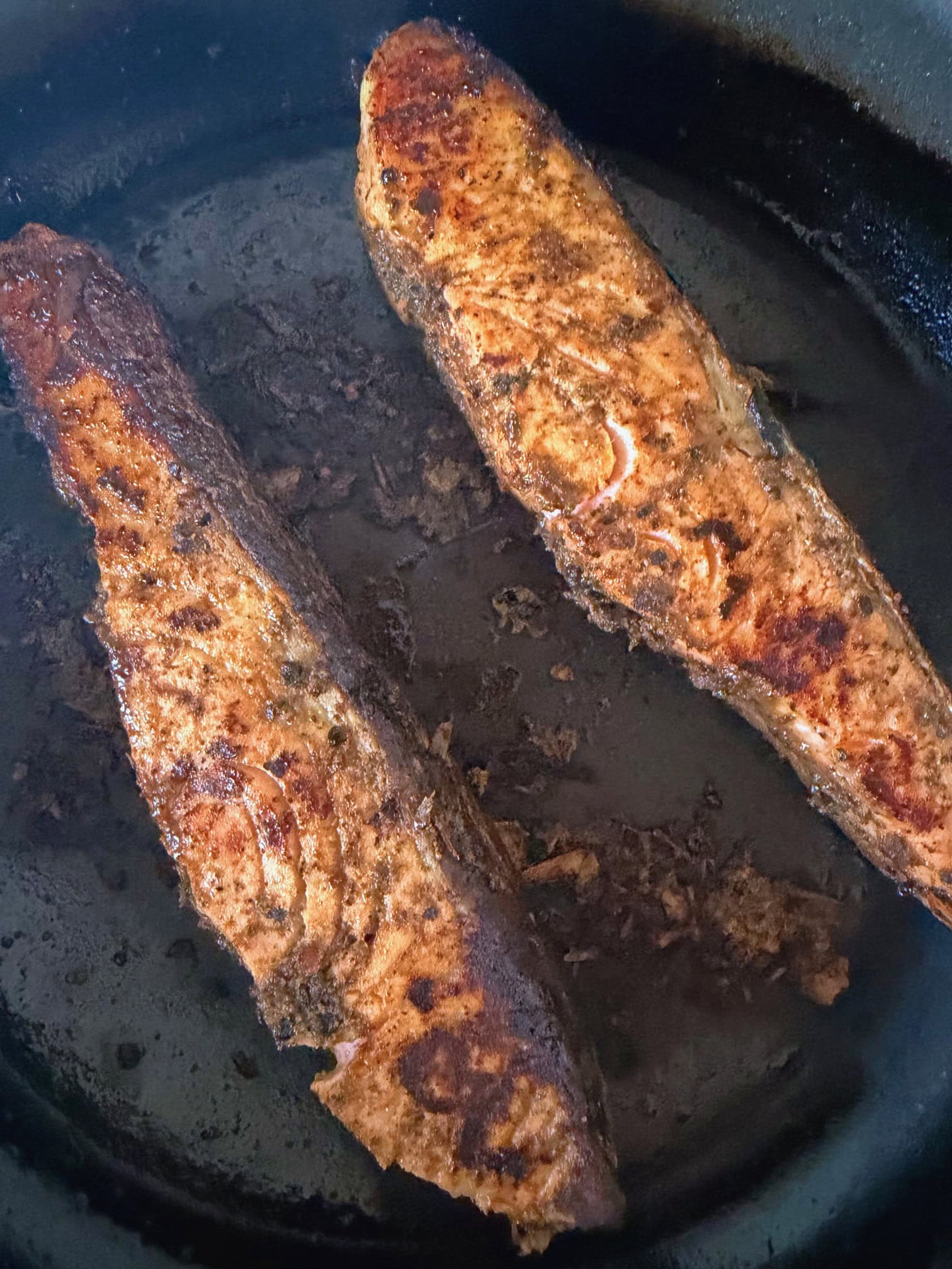cooking salmon in a pan