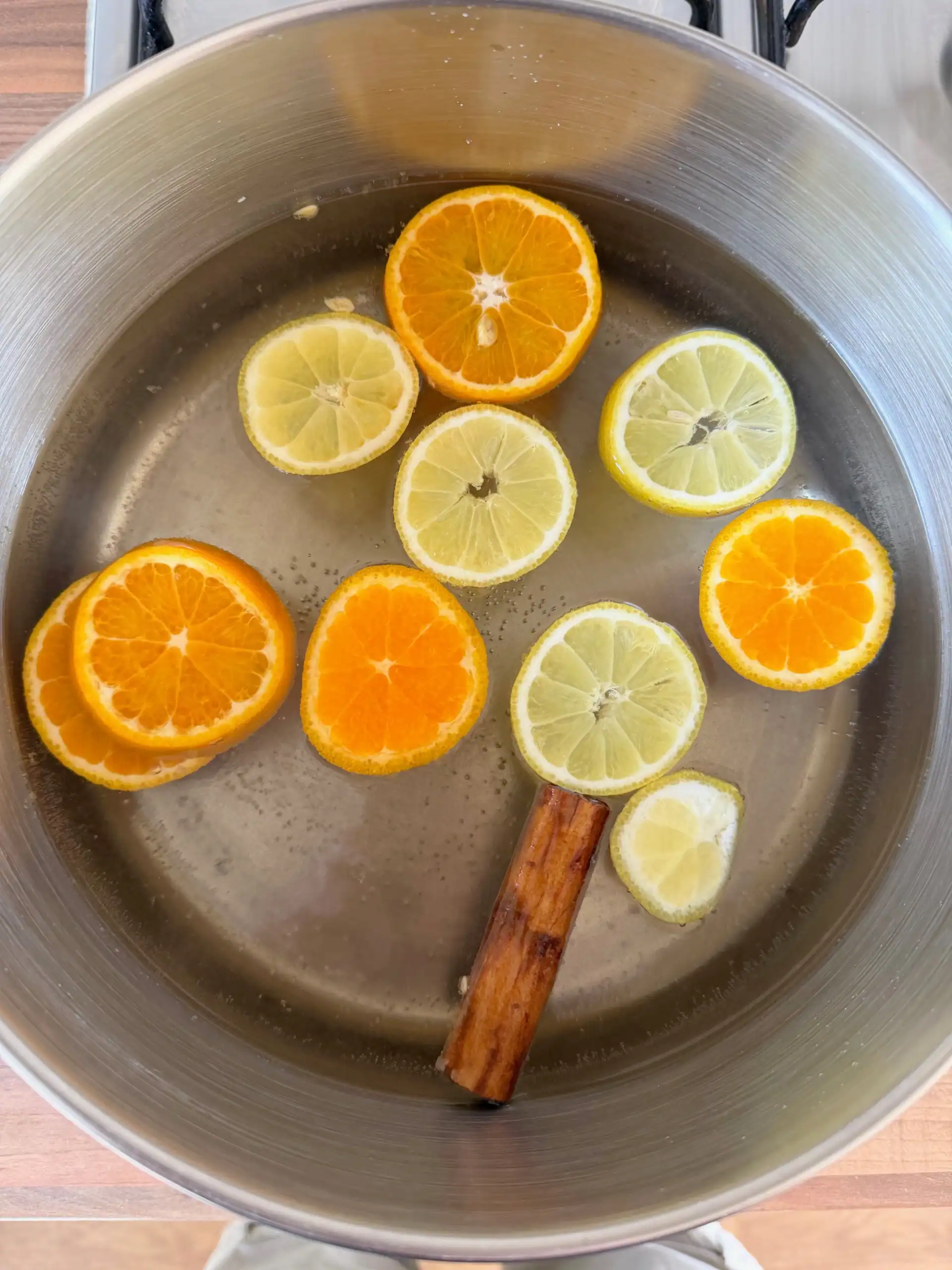 poaching liquid with oranges, lemons and cinnamon stick