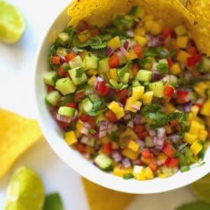 Colourful Mango salsa in a bowl with lime and mint