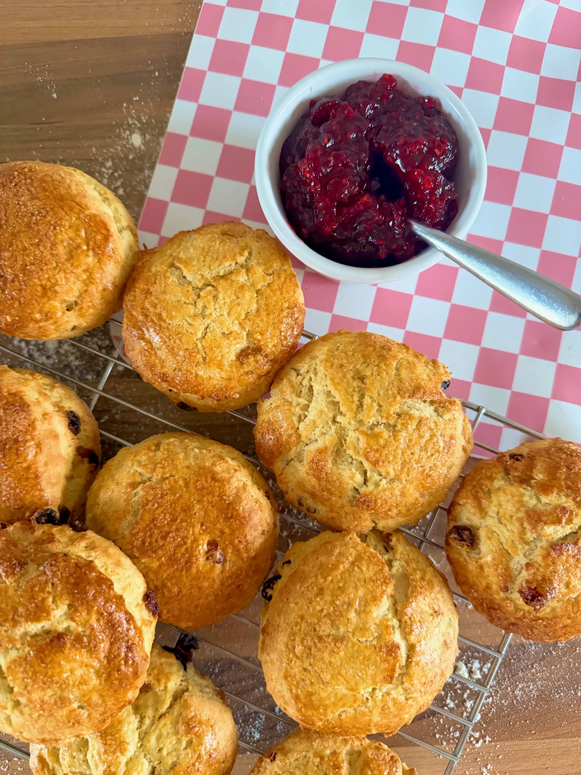 Scones cooling on a rack with jam