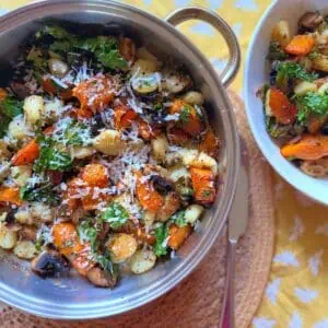 butternut squash gnocchi in a pan with fresh parmesan