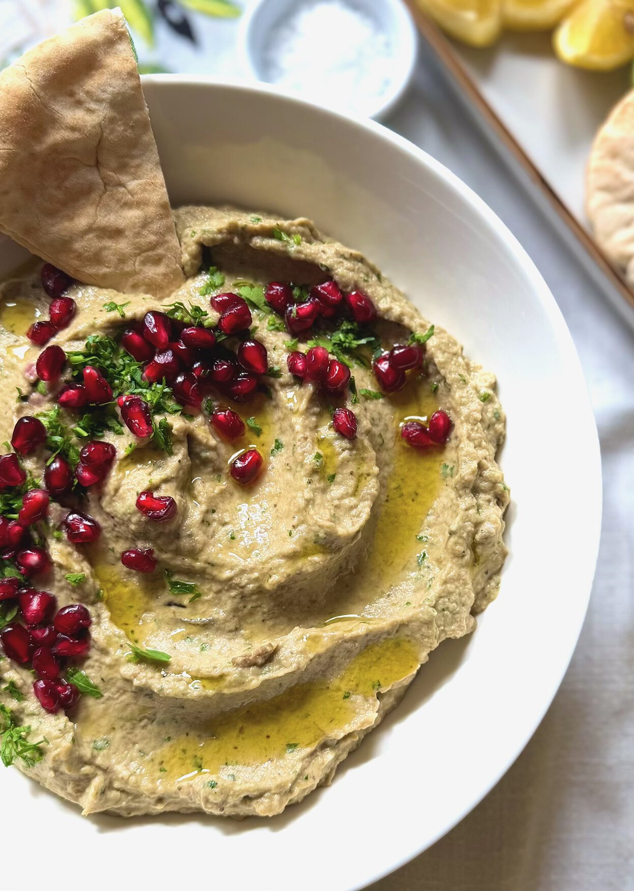 baba ganoush close up with red pomegranate