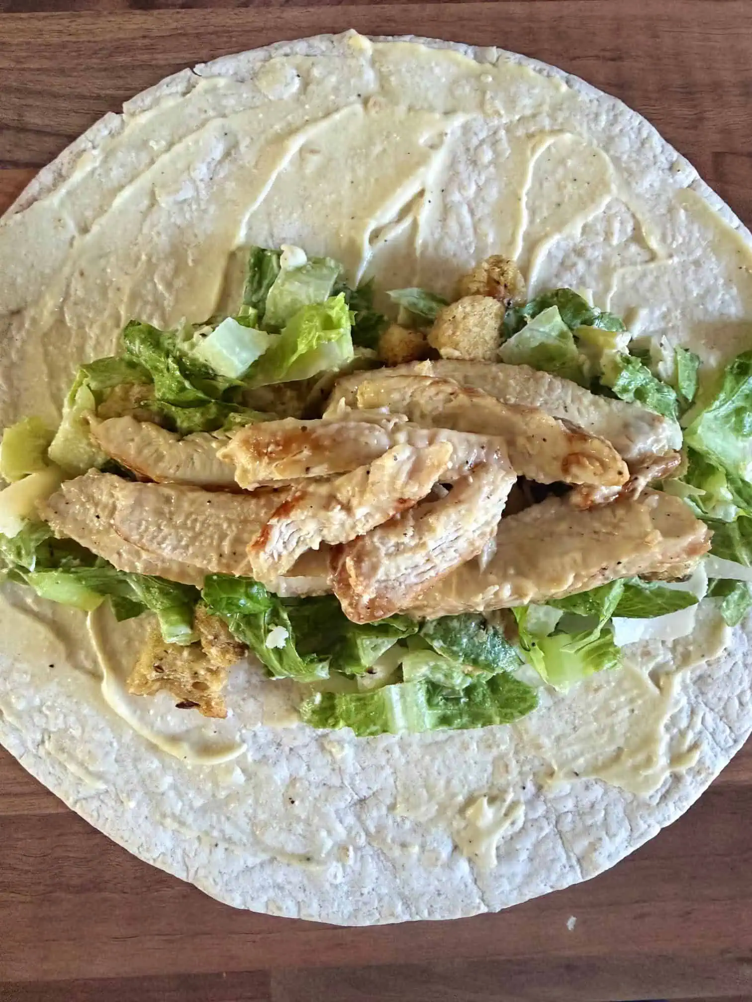 Caesar salad and chicken on a wrap