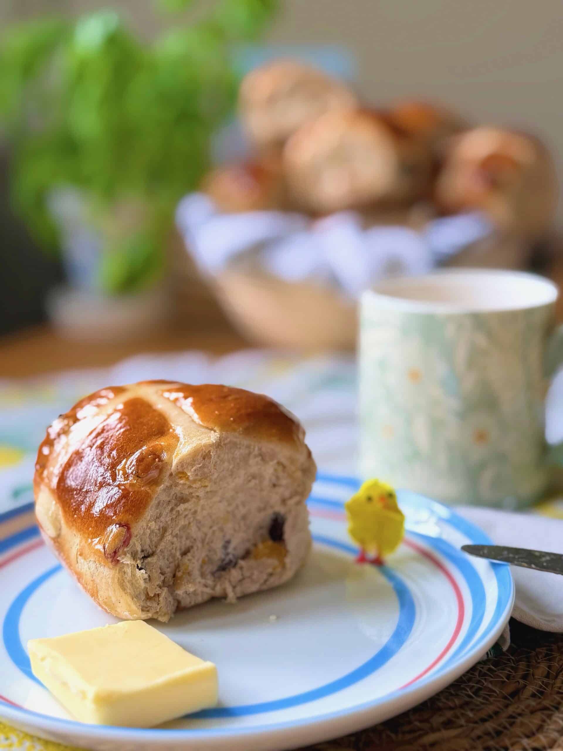 hot cross bun with yellow chick on a plate