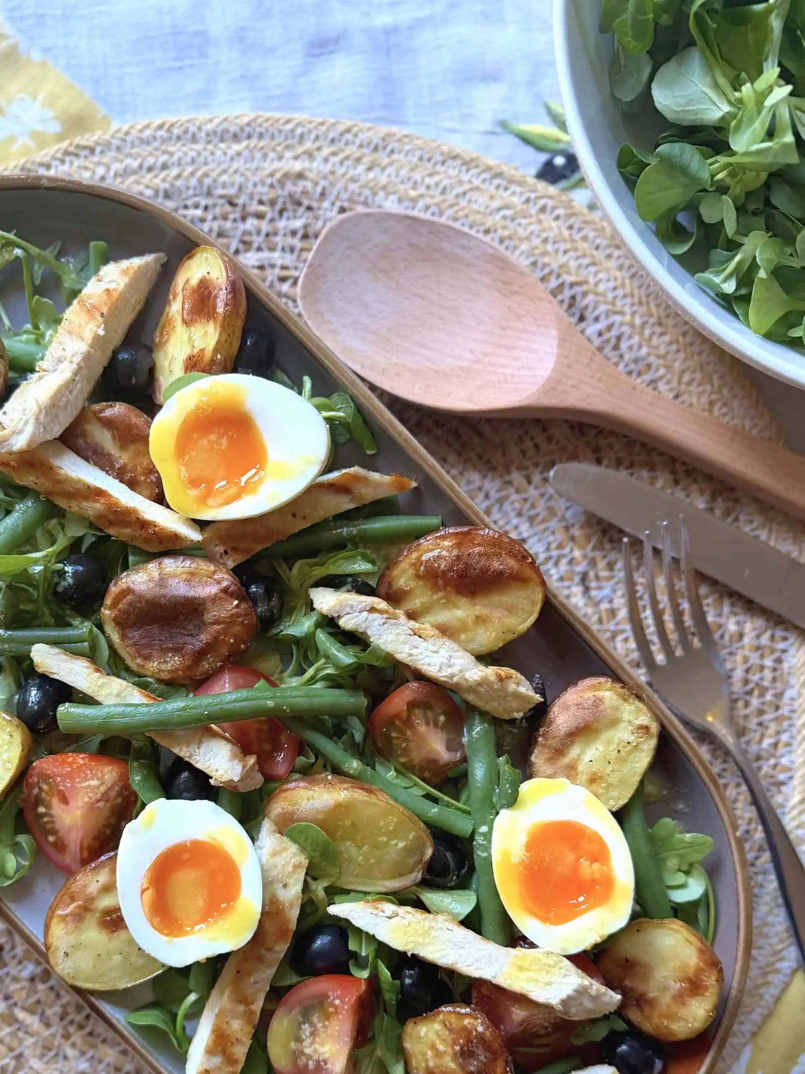 Nicoise salad with wooden spoon