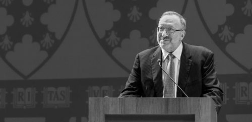 Warren Buffett, renowned investor, delivering a speech at a financial event.