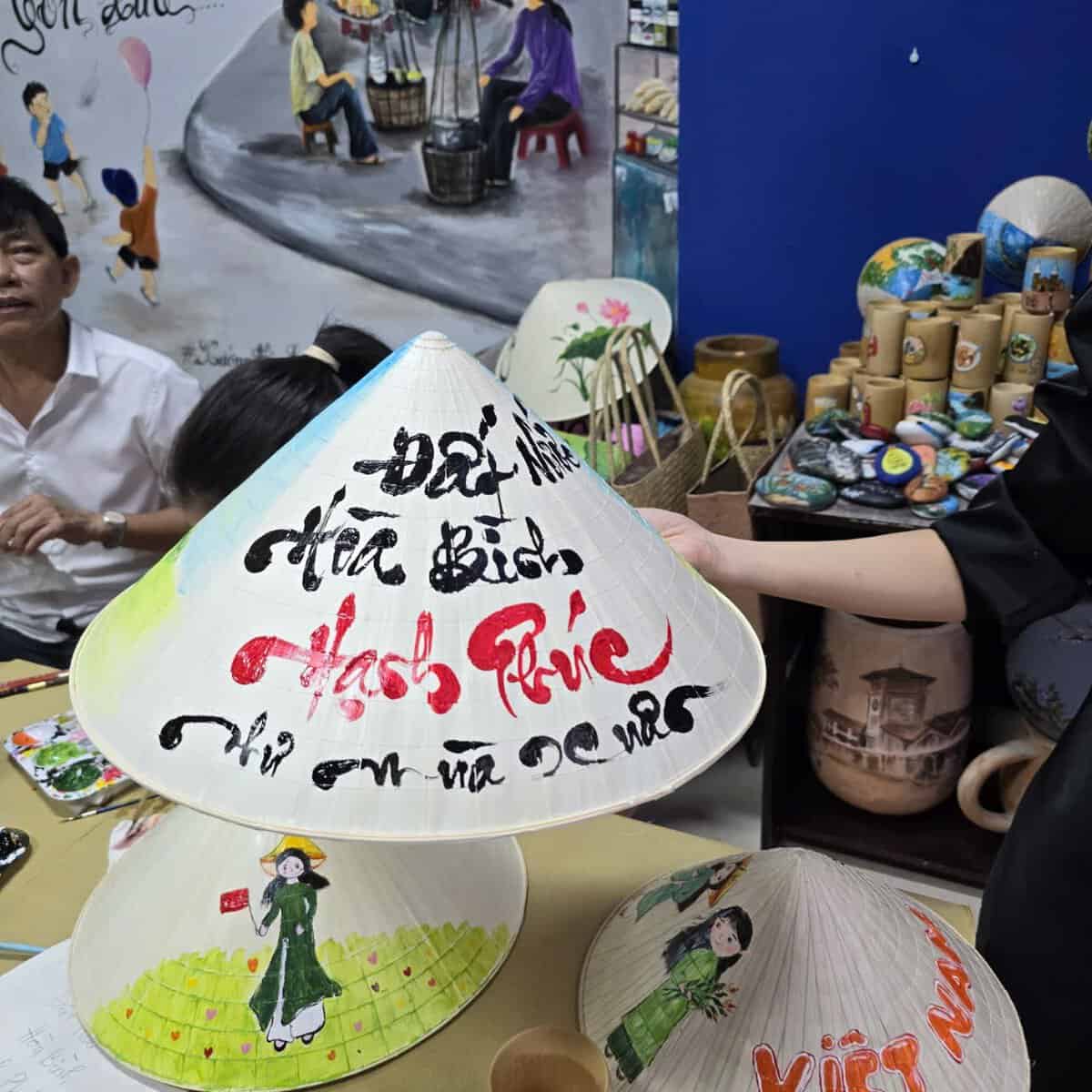 Hand painted Vietnamese conical hat souvenir at Dasaque craft workshop in Ho Chi Minh City
