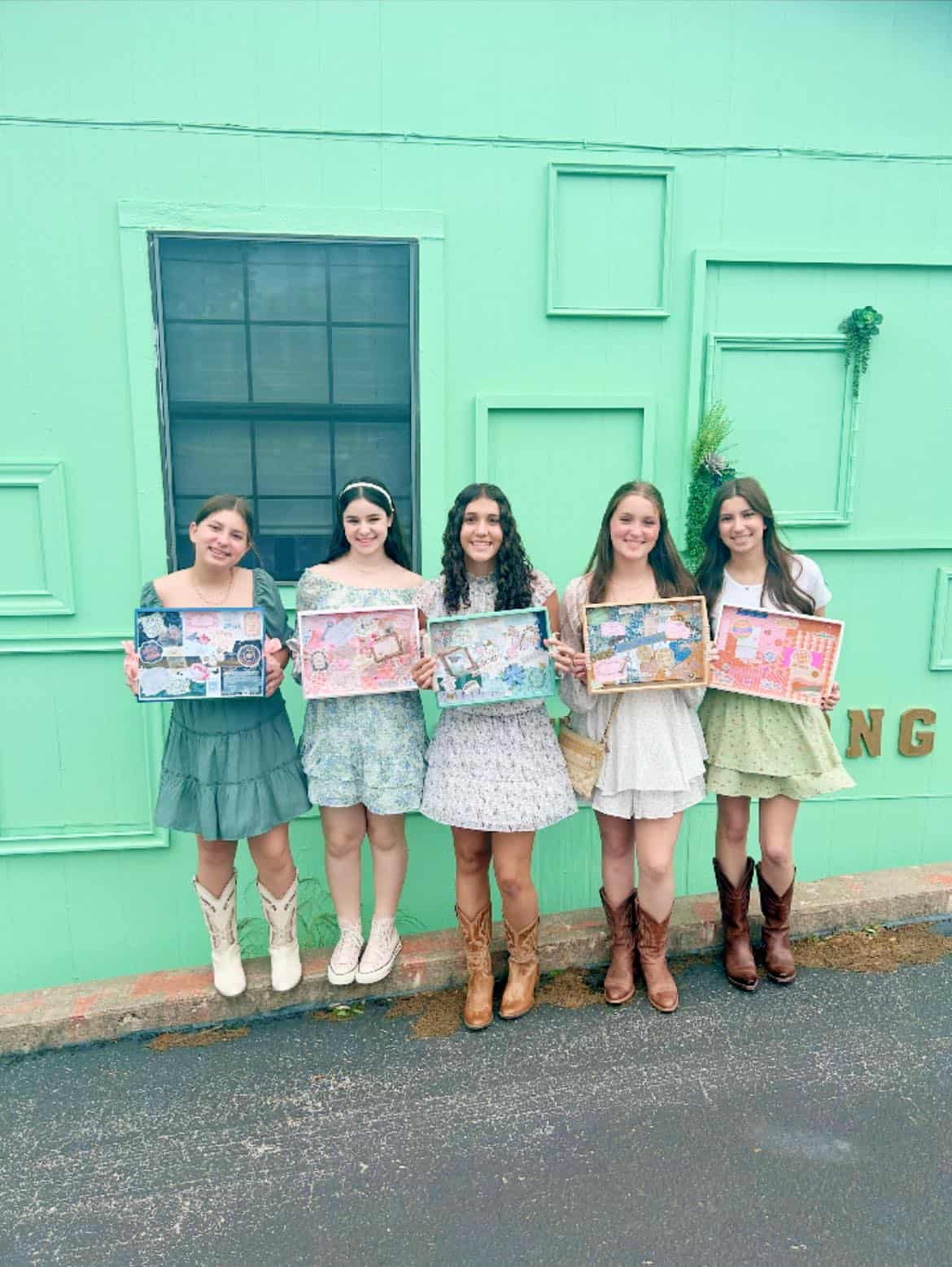 Calendar featuring five women holding planners outdoors.