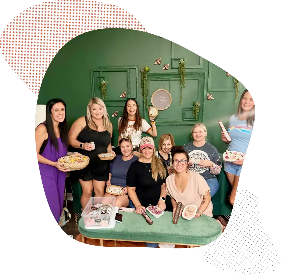 Group of women celebrating with cake and drinks at Dax + Jade studio.
