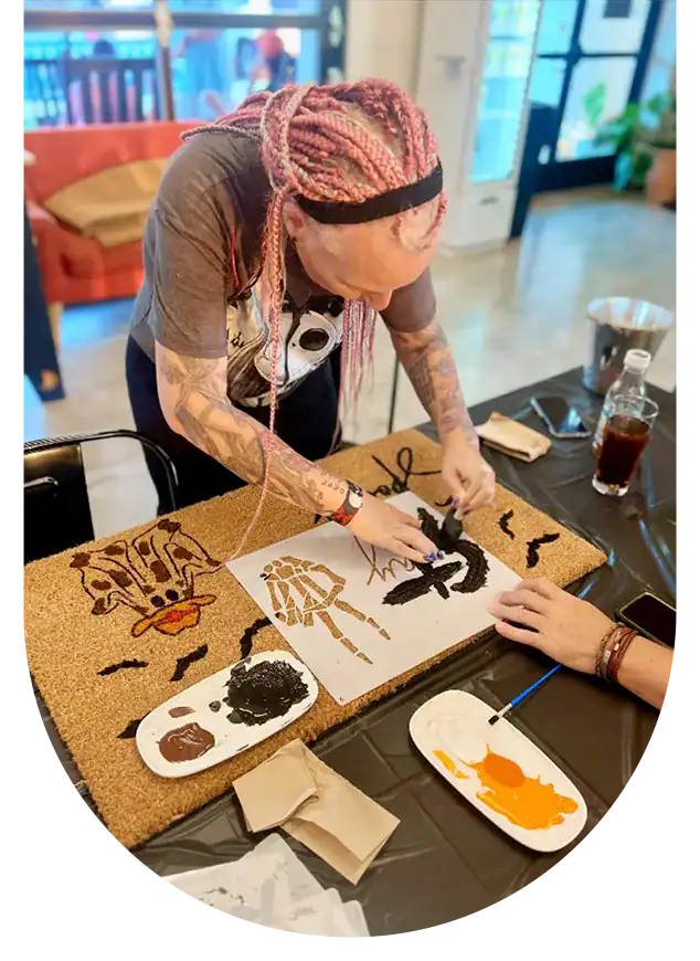 Hand-painting artwork by a Dax + Jade brand ambassador during a workshop.