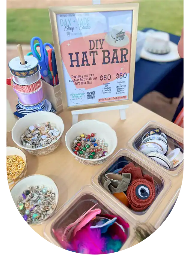 Customizable DIY hat station with craft supplies and accessories for fun events.