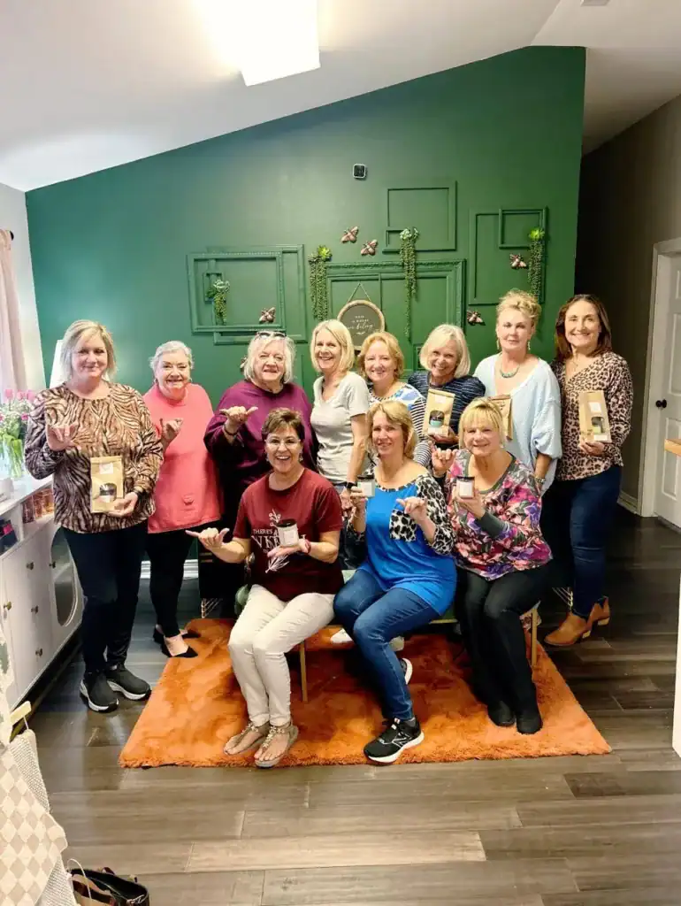 Celebrating birthdays with a joyful group of women in a cozy, decorated indoor setting.