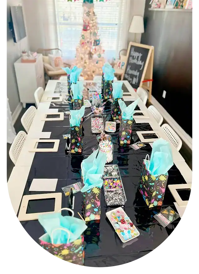 Vibrant birthday celebration setup with gift bags, party favors, and a decorated cake on a dining ta.