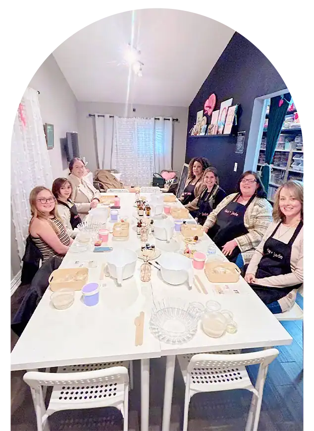 Group of women enjoying a themed cooking class around a large table.