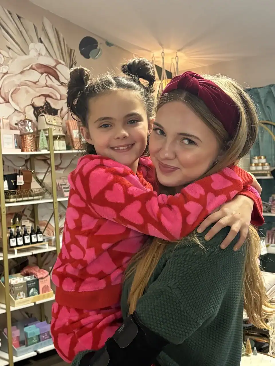 Child hugging caregiver in after school activity setting.