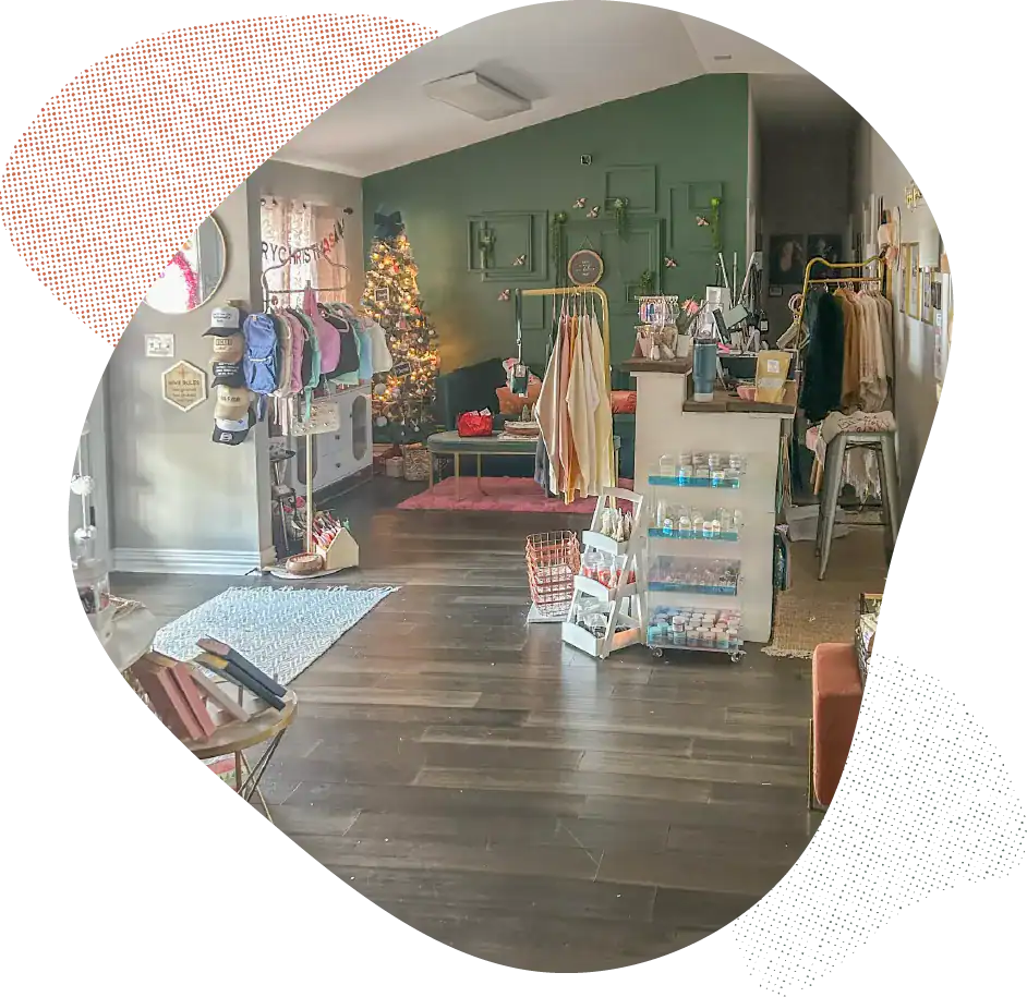 Bright boutique shop with clothing racks and holiday decor.