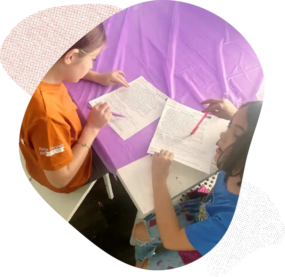 Children working on homework during after school program session.