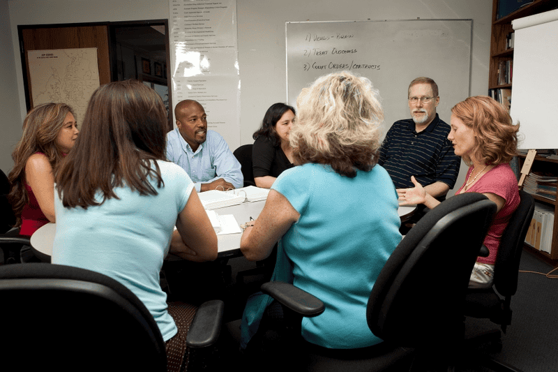Group of people brainstorming over a table