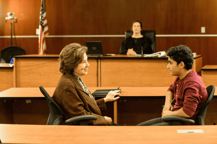Supportive court hearing for CASA volunteer and youth in Douglas County, emphasizing child advocacy and court proceedings.
