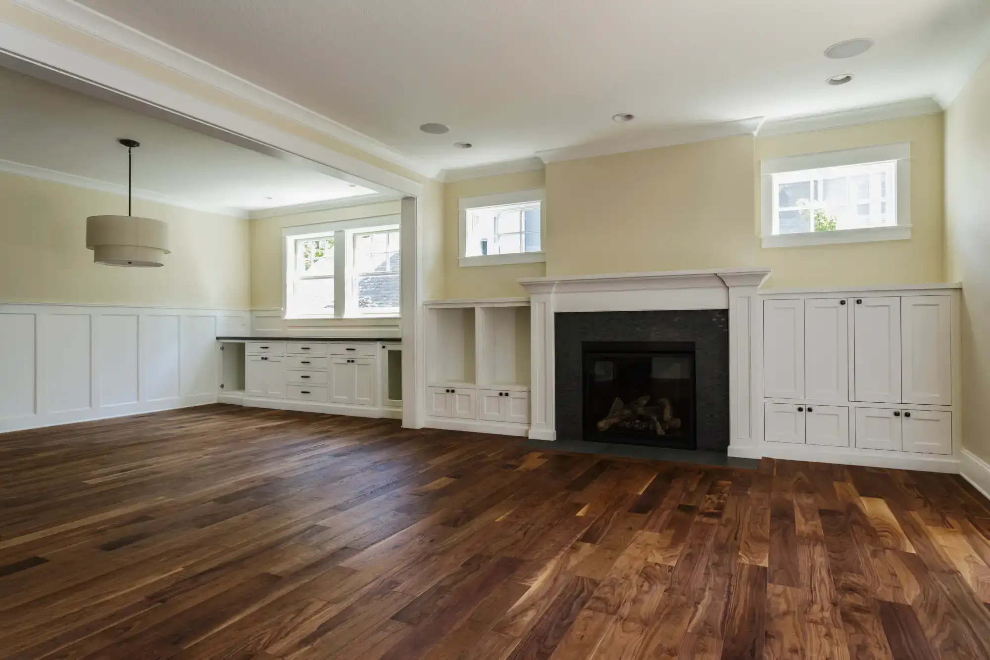 Spacious living room featuring a cozy fireplace and custom built-in cabinets, perfect for family gat.