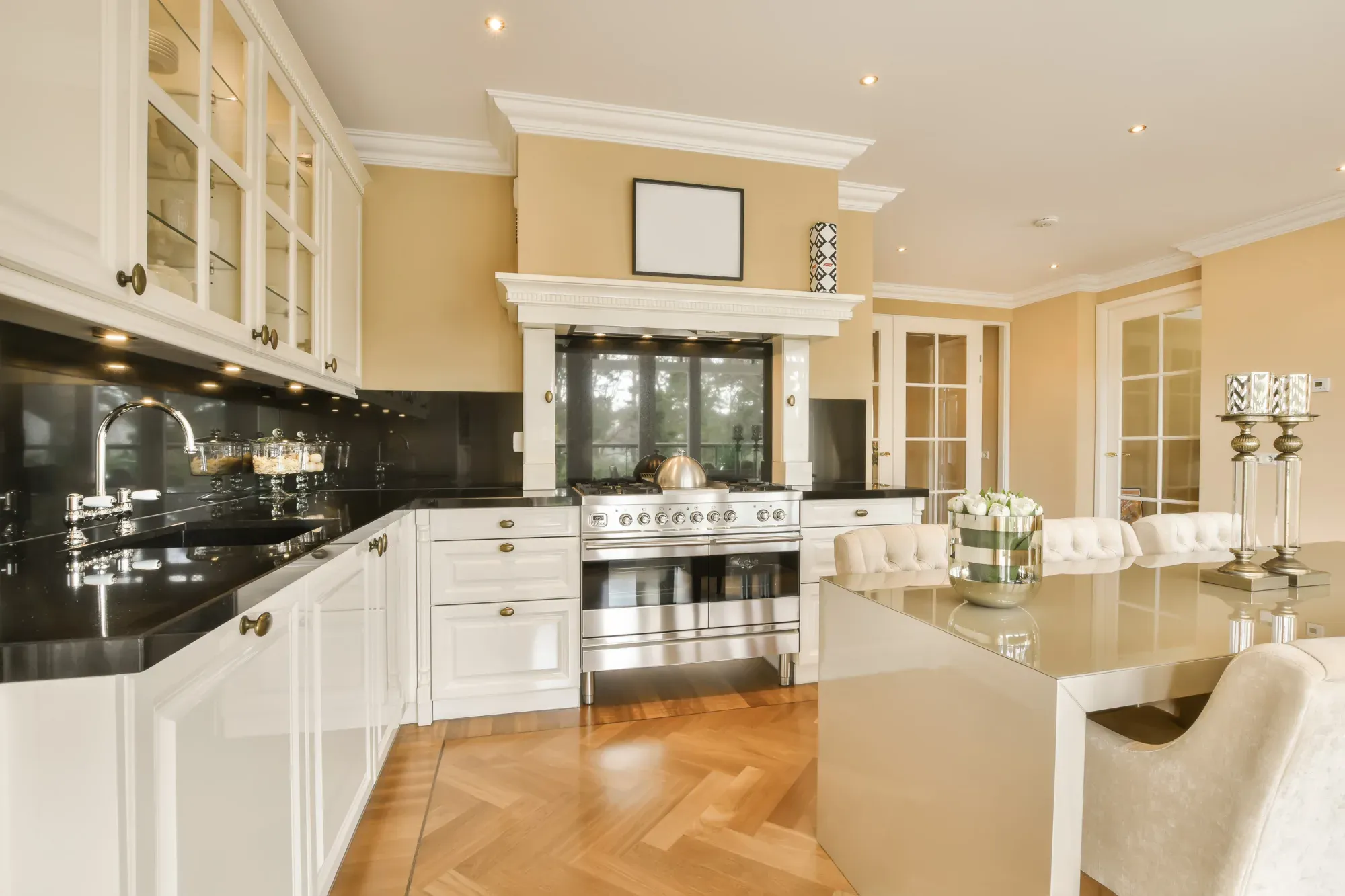 Elegant kitchen with white cabinetry and black countertops in San Jose.