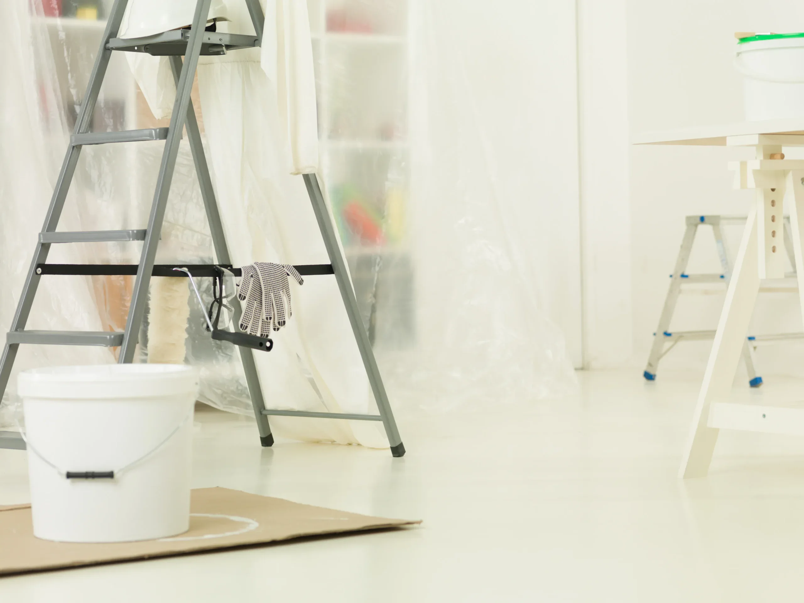 Remodeling tools and ladder in a bright, clean home renovation workspace.
