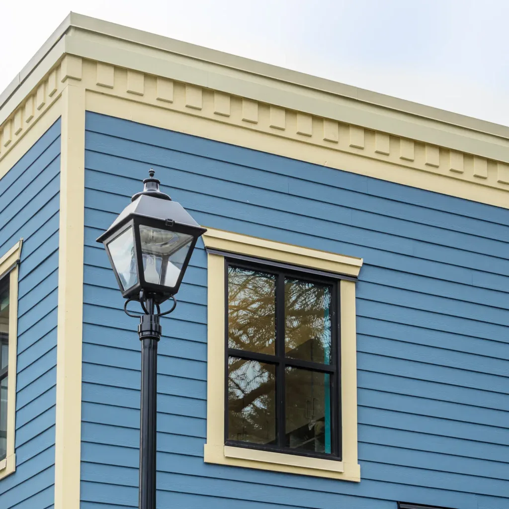Expert siding installation on a blue house with beige trim in San Jose.