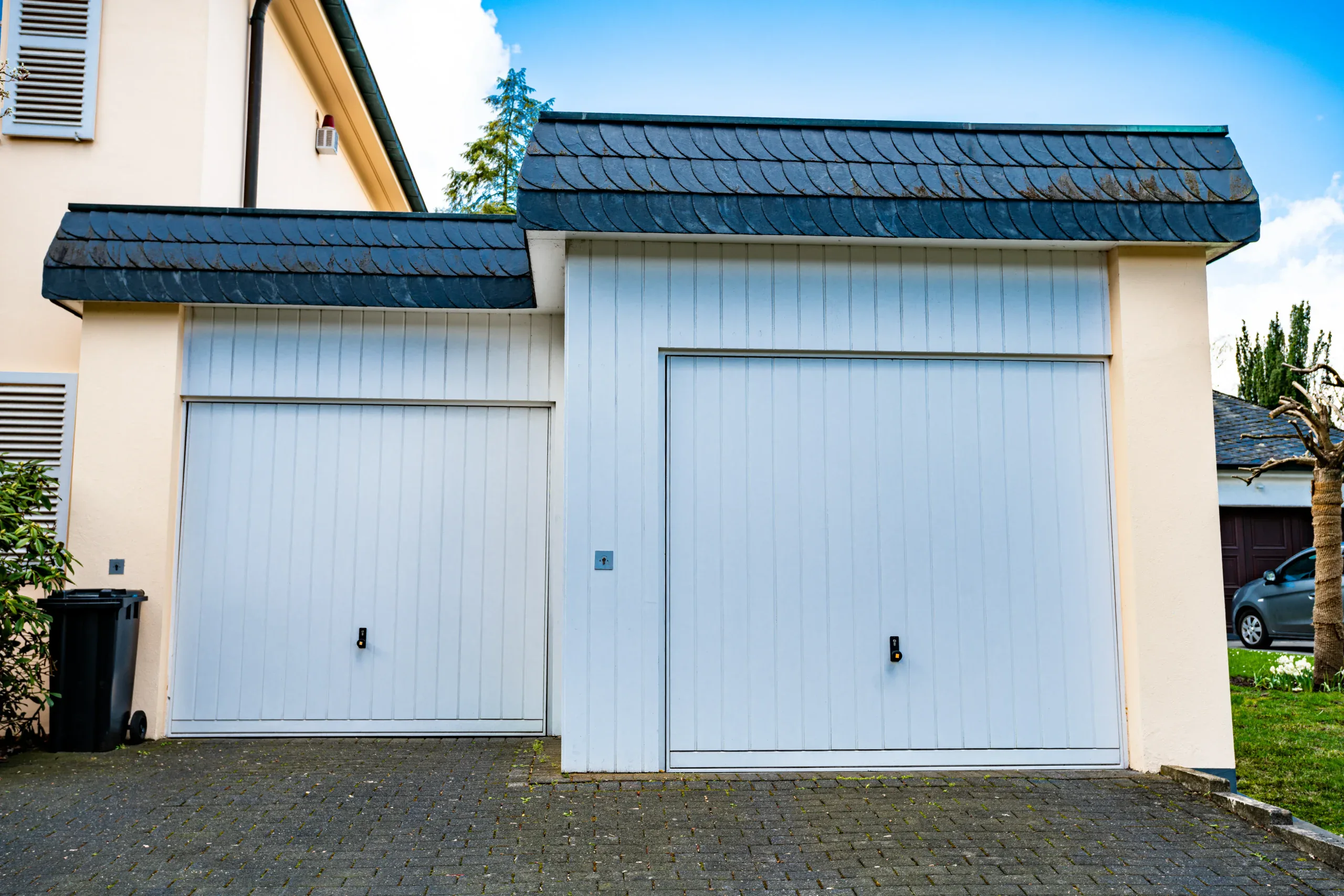 Modern white garage doors with sleek design and durable construction.