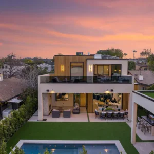 Modern house with pool and outdoor living spaces at sunset