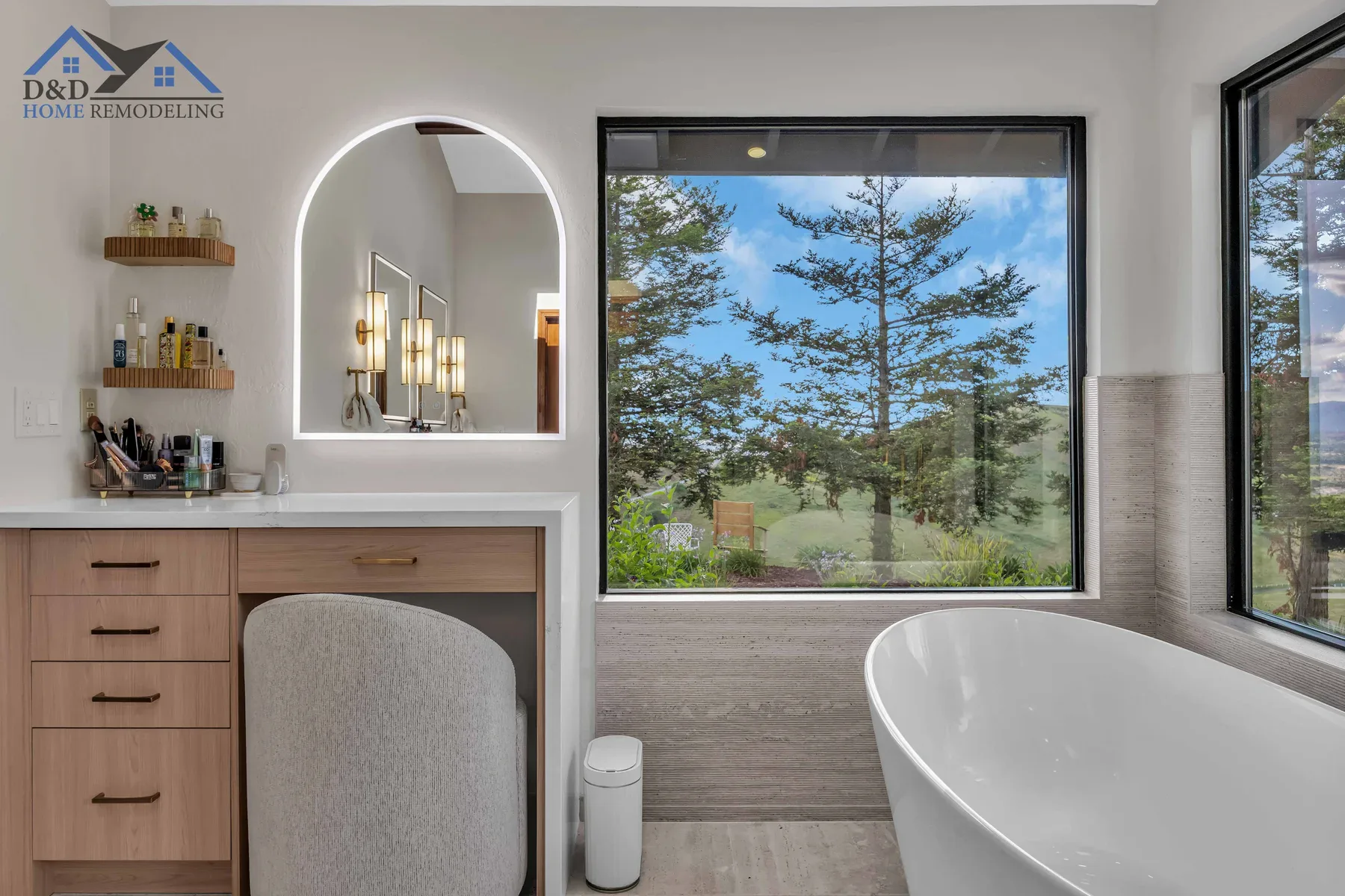 Bright modern bathroom with large windows and a freestanding bathtub.