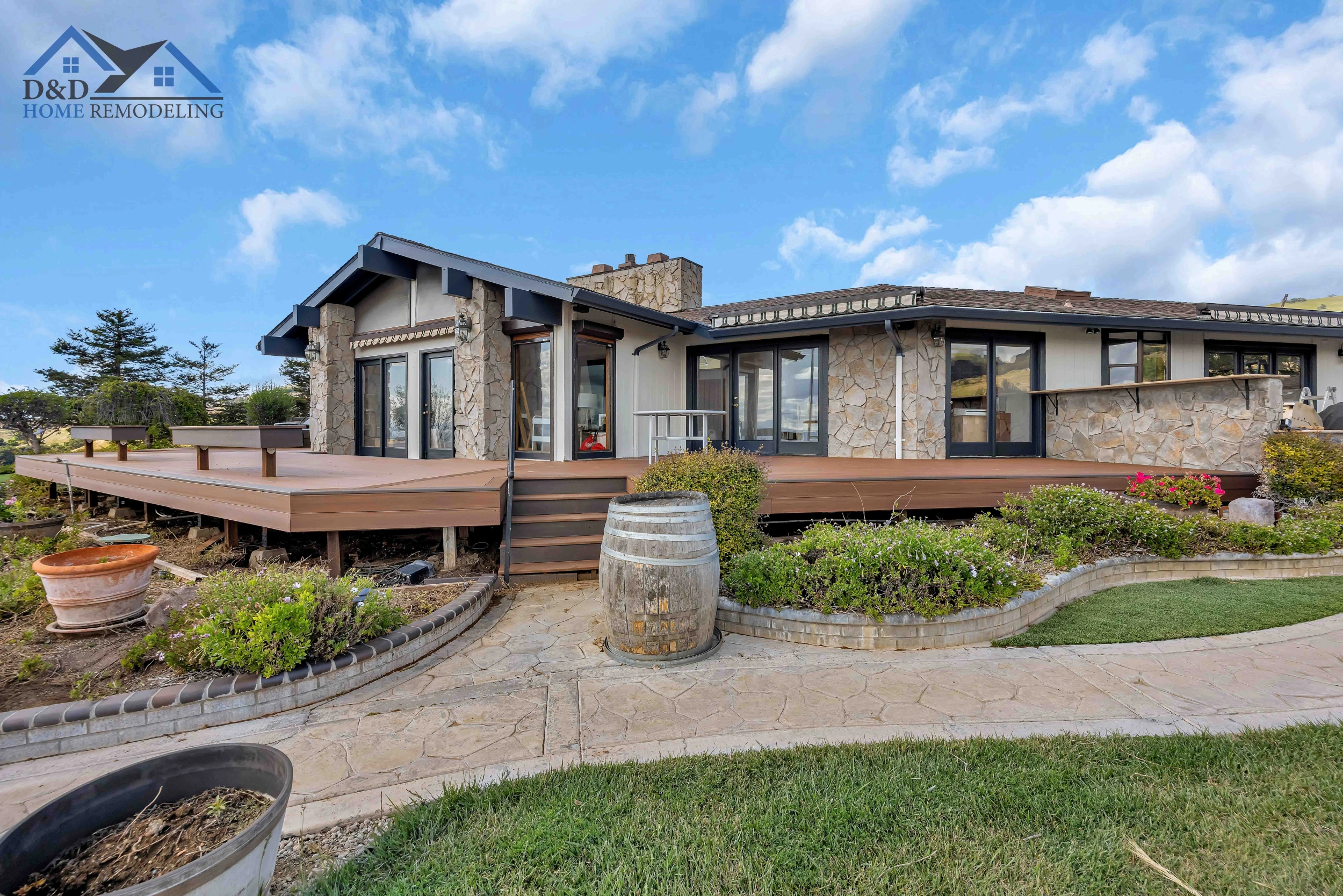 Modern home exterior with large deck and stone accents in San Jose.