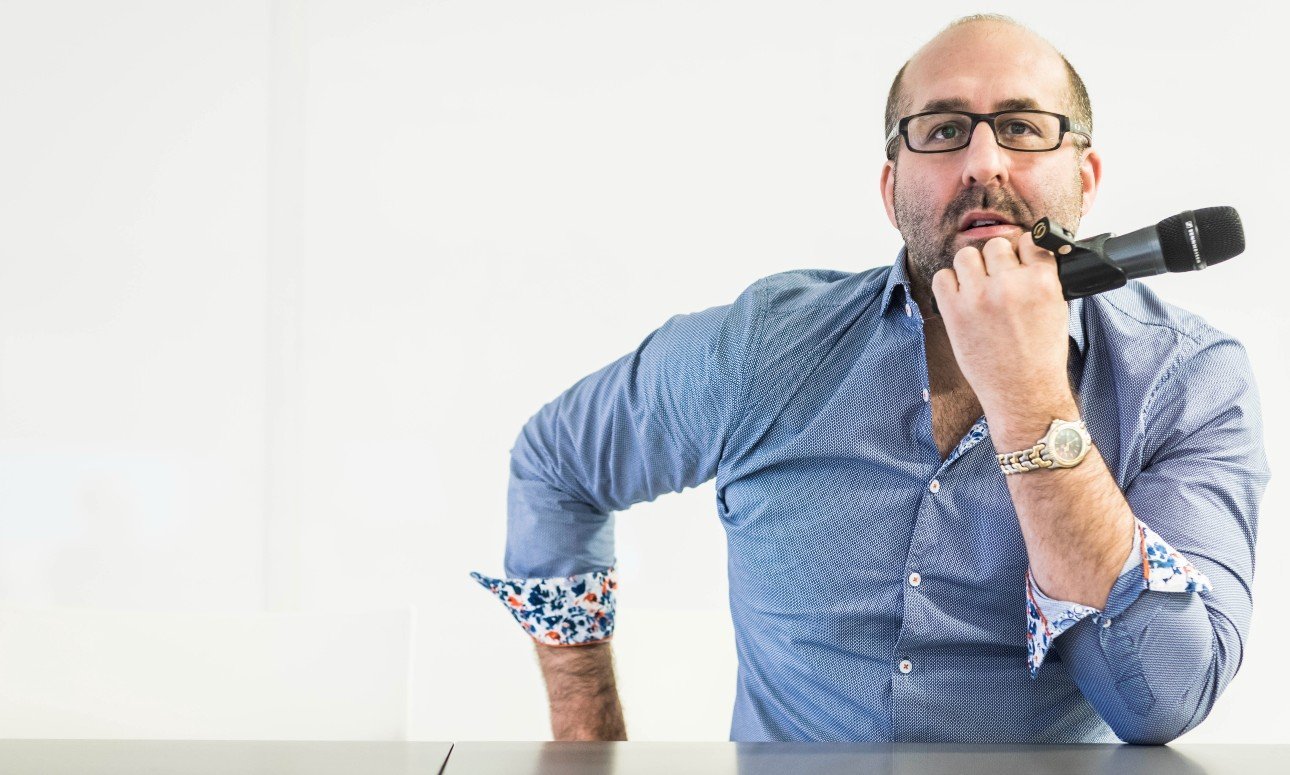 Jason Della Rocca professional speaker profile image featuring a classic thinking pose against a clean white studio background.