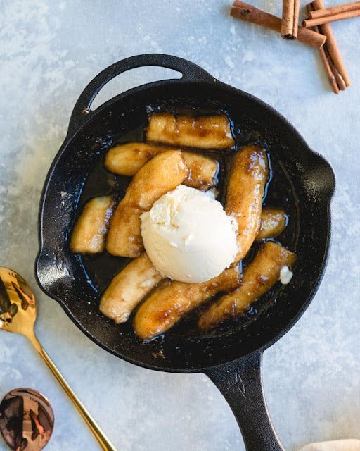 Bananas Foster in skillet over ice cream