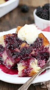 Cozy blackberry bread pudding served warm with maple syrup and fresh blackberries