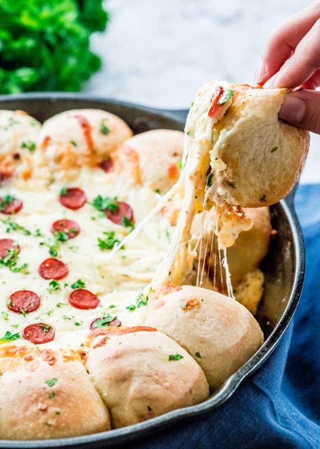 Cheesy skillet pizza dip topped with pepperoni.