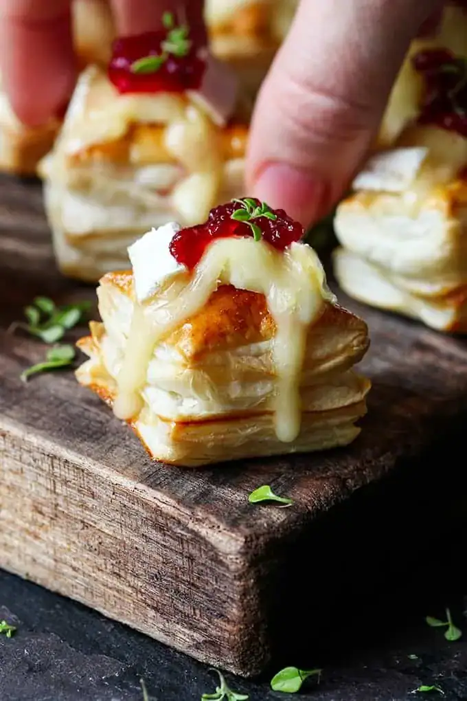 Cranberry brie bites in puff pastry on a tray