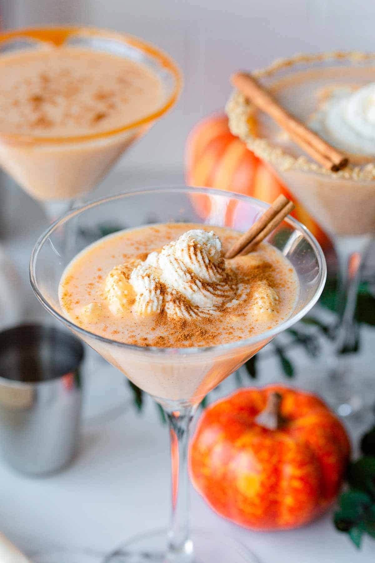 Pumpkin pie martini with cinnamon and whipped cream — cozy holiday drink