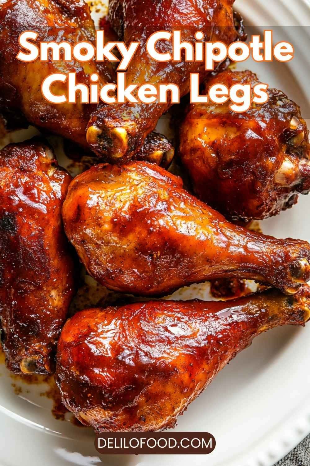 Smoky chipotle chicken legs with a spicy reddish glaze, crispy golden skin, oven-baked drumsticks seasoned with chipotle and smoked paprika, warm appetizing lighting