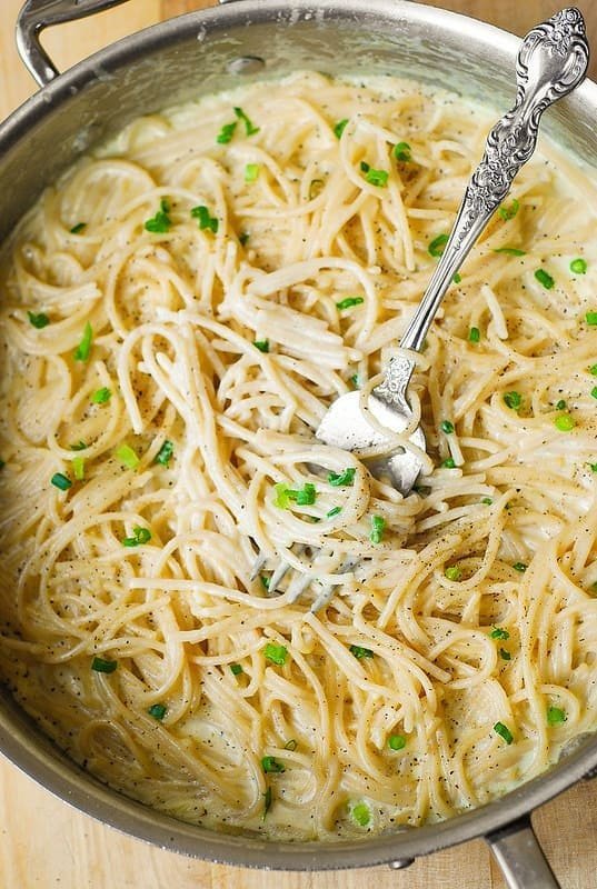 Four cheese garlic cream pasta sauce served over spaghetti