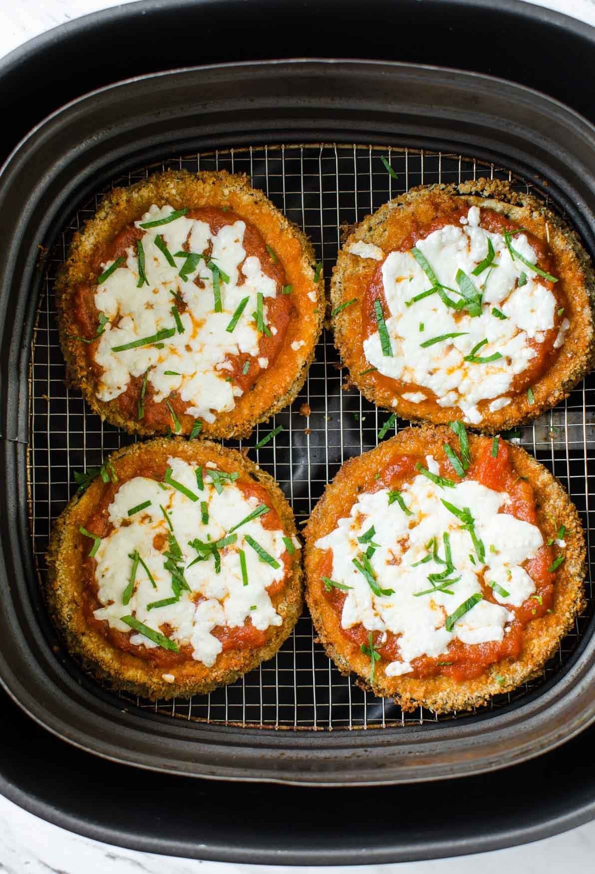 Air fryer eggplant parmesan with melted cheese.