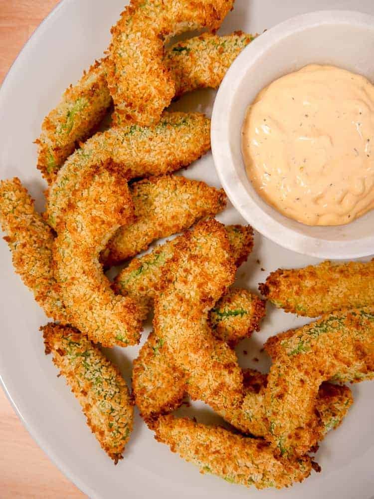 Air fryer avocado fries served with dipping sauce.