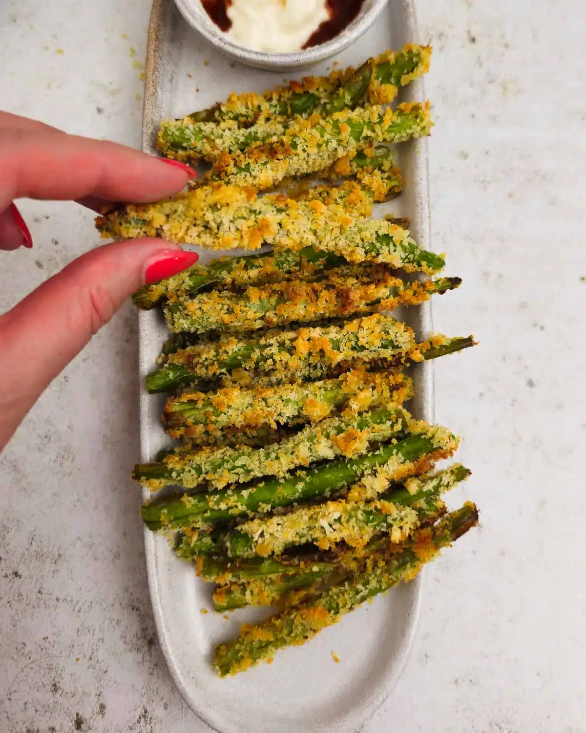 Crispy air fryer green bean fries served with dip.