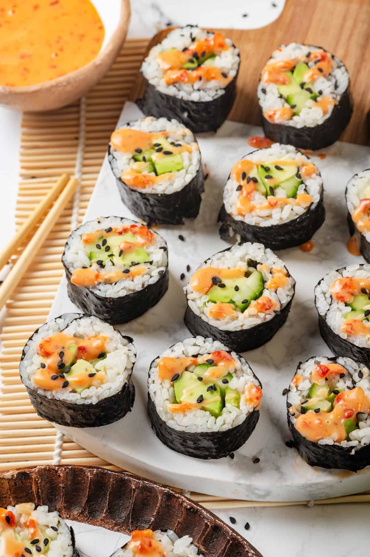 Homemade avocado sushi rolls sliced and served on a plate