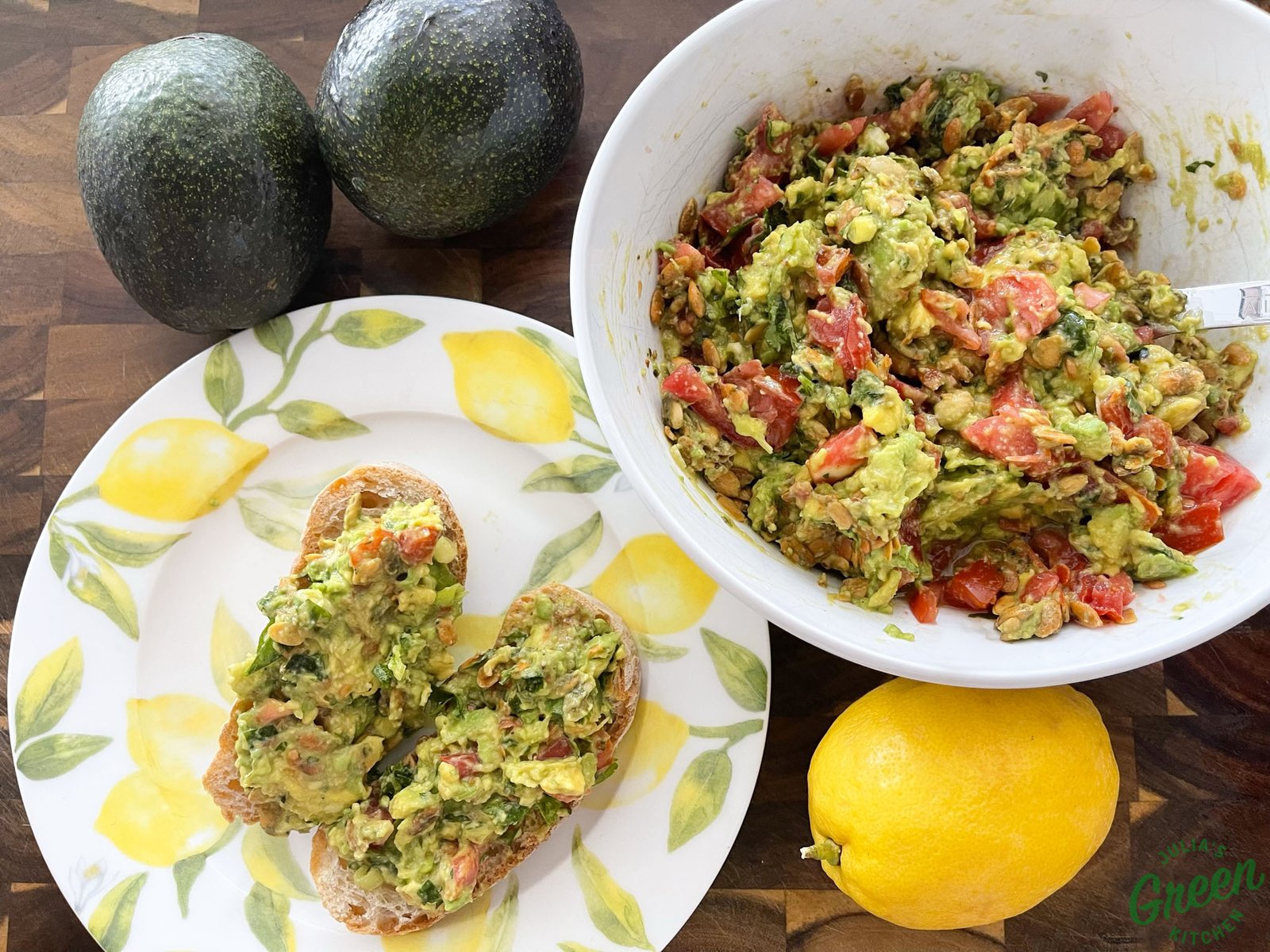 Avocado salad with tomatoes and pumpkin seeds served in a bowl