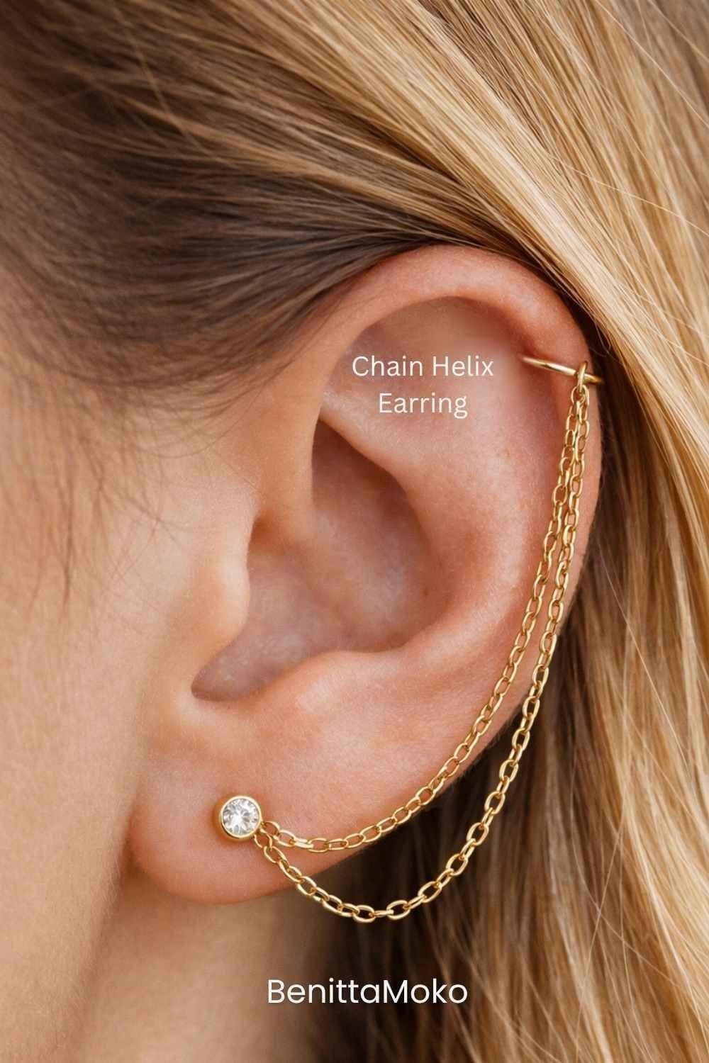 Chain helix earring with gold upper ear hoop connected to a lobe stud by two delicate chains in warm natural tones