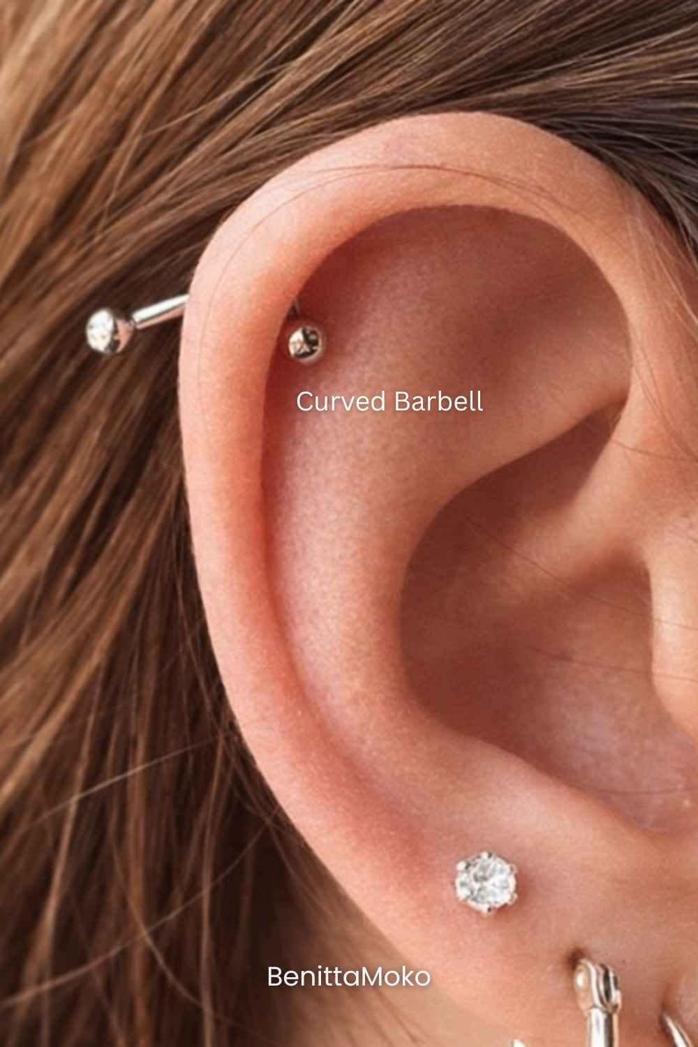Curved barbell helix piercing with minimal cartilage jewelry, close-up of ear with peach skin tones and natural styling
