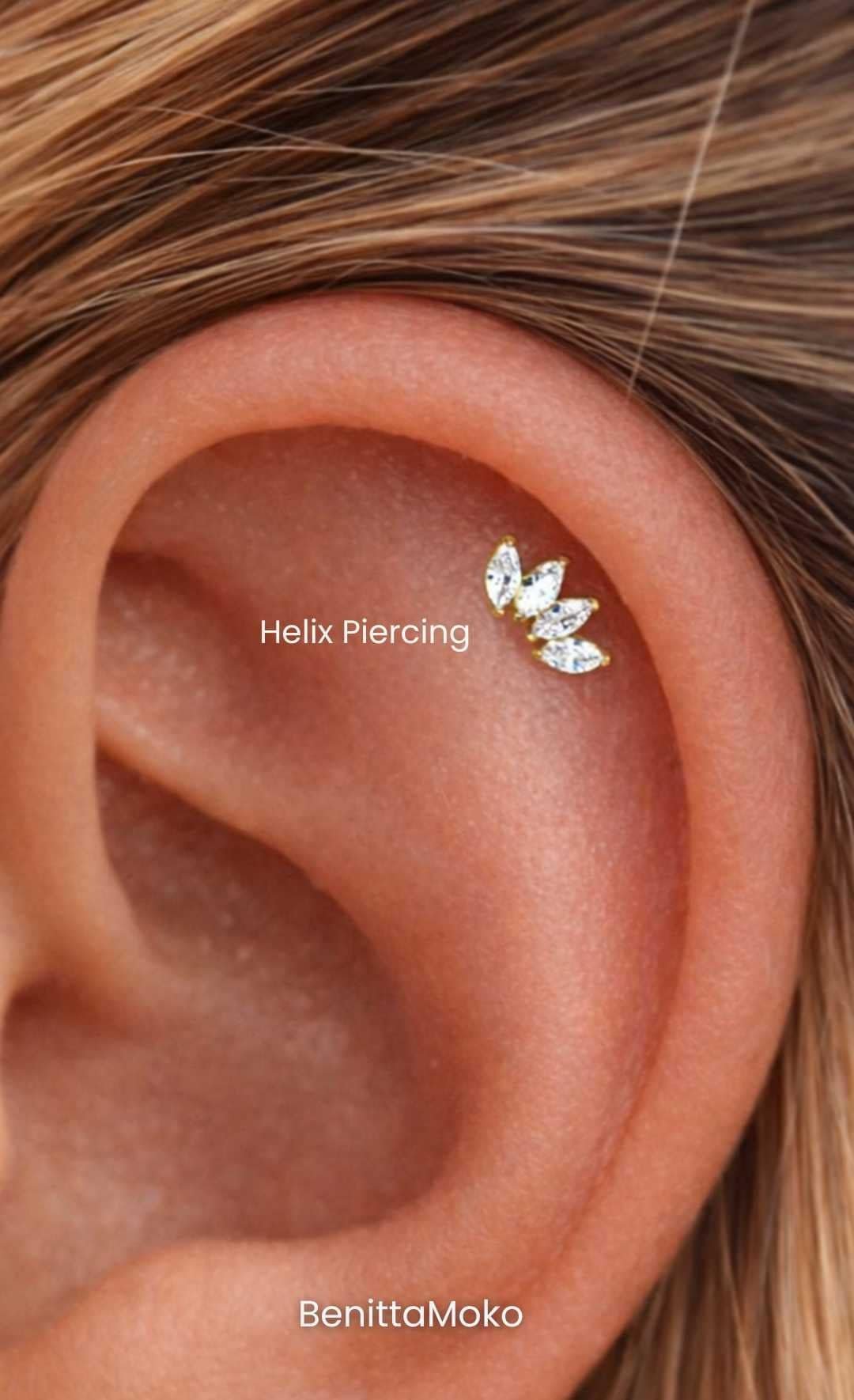 Helix piercing close-up with gold cartilage earring, natural ear anatomy and minimal jewelry styling
